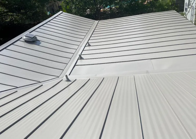 Solar attic fan installed on a metal roof for Roof Ventilation in Sunnyside